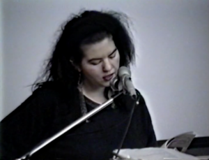 Video still of Judy Radul reading at Capilano College in 1992. Courtesy of SFU Special Collections.