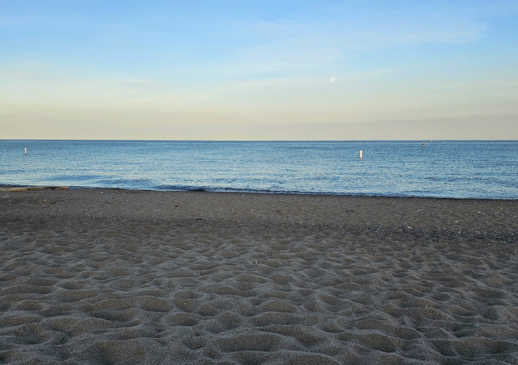 An image of a sandy beach looking out at the water.