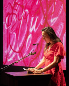 The Capilano Review's Literary Editor Deanna Fong introducing "Dear Friends &" in September 2024 at the Western Front. With artwork by Jonathan Alfaro. Photo by Rachel Topham Photography. Courtesy of Western Front.